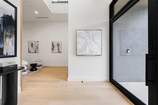 hall featuring visible vents, recessed lighting, light wood-type flooring, and baseboards