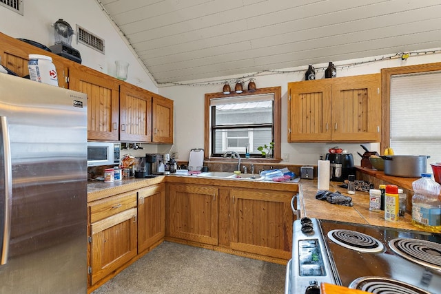 1811 Waterston Ave, Austin, TX 78703 - kitchen with stainless steel appliances, a sink, vaulted ceiling, light countertops, and wood ceiling