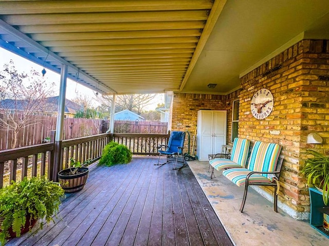 wooden terrace featuring fence