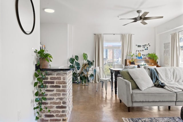 living area featuring concrete floors and a ceiling fan