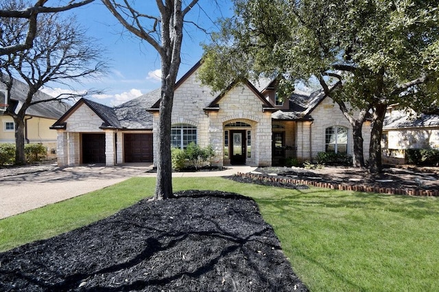 9512 Palmbrook Dr, Austin, TX 78717 - french country style house with stone siding, a garage, driveway, and a front lawn