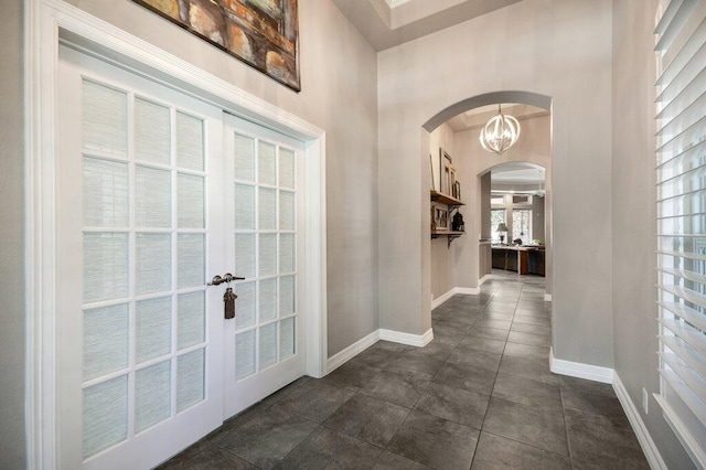 9512 Palmbrook Dr, Austin, TX 78717 - foyer entrance featuring arched walkways, french doors, baseboards, and a high ceiling
