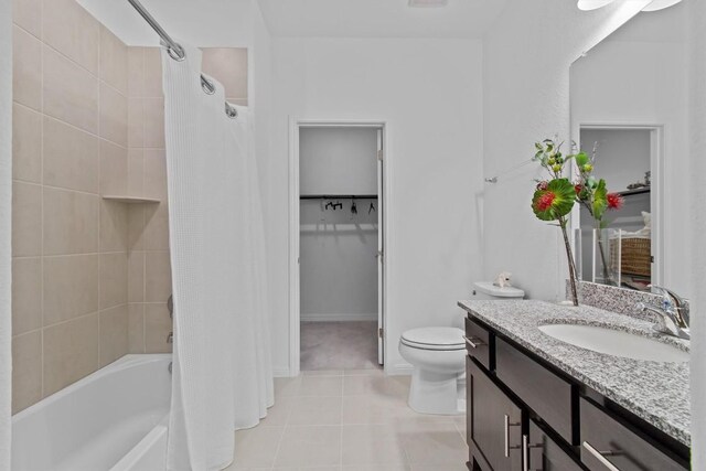 4737 Modena Bay Bnd, Leander, TX 78641 - bathroom with toilet, vanity, a spacious closet, shower / bath combination with curtain, and tile patterned flooring
