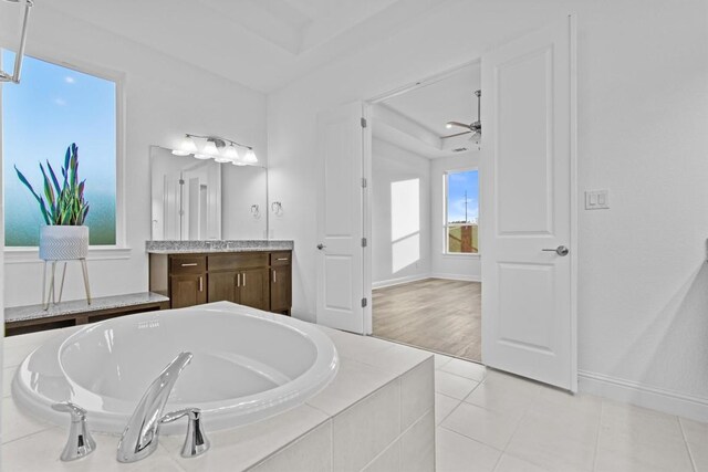 4737 Modena Bay Bnd, Leander, TX 78641 - bathroom featuring a garden tub, vanity, tile patterned floors, and a ceiling fan