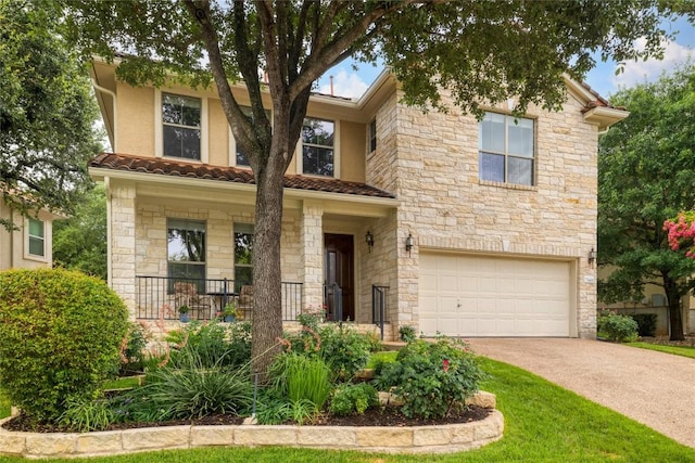 view of front of house featuring concrete driveway, an attached garage, a tile roof, and stucco siding