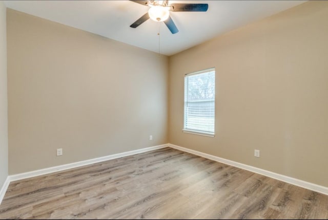 unfurnished room with ceiling fan, light wood-type flooring, and baseboards