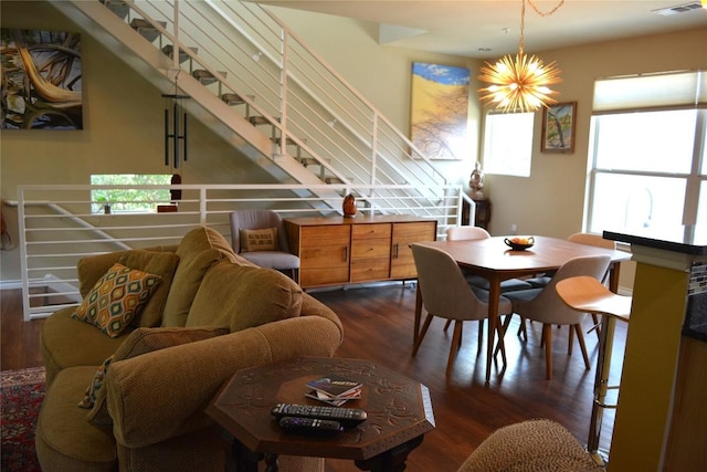 interior space featuring a chandelier, stairs, wood finished floors, and visible vents