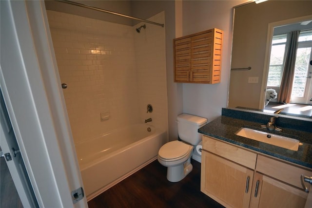 full bath featuring vanity, tub / shower combination, wood finished floors, and toilet