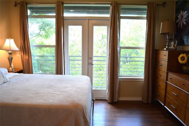 bedroom with access to outside, baseboards, and dark wood finished floors