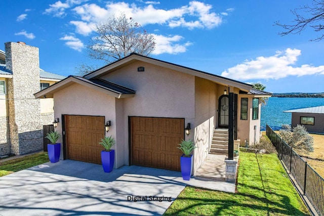 view of front of house featuring a chimney, stucco siding, an attached garage, fence, and driveway