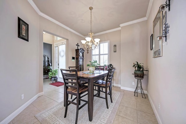 dining space featuring light tile patterned floors, baseboards, and crown molding