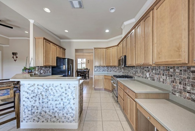 kitchen featuring stainless steel appliances, light countertops, visible vents, light tile patterned flooring, and a peninsula