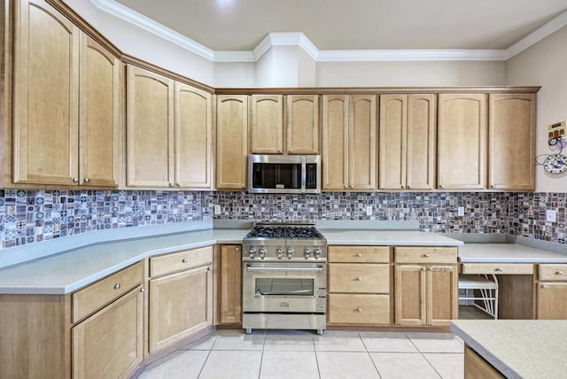 kitchen with light tile patterned floors, decorative backsplash, appliances with stainless steel finishes, light countertops, and crown molding