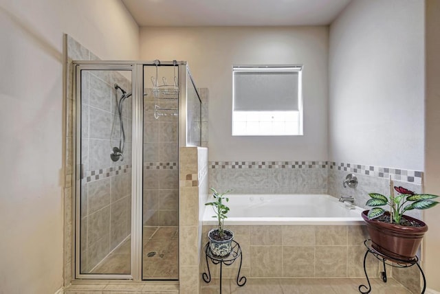 bathroom with a garden tub and a shower stall