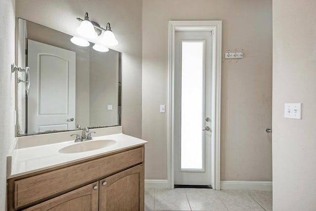 bathroom featuring tile patterned flooring, vanity, and baseboards