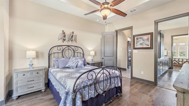 bedroom with baseboards, visible vents, ceiling fan, and wood finished floors