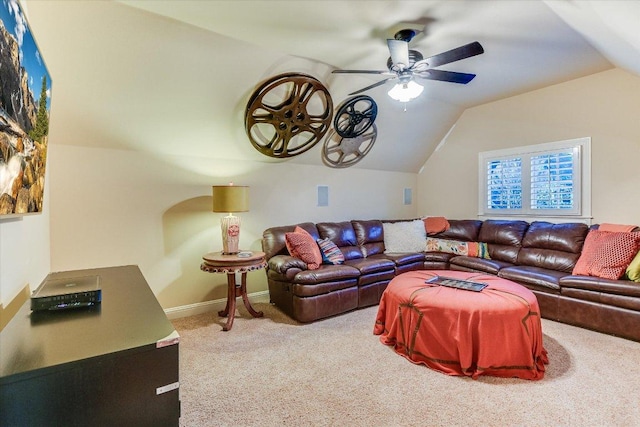 living area with vaulted ceiling, ceiling fan, carpet, and baseboards