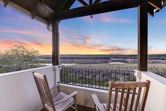 view of balcony at dusk