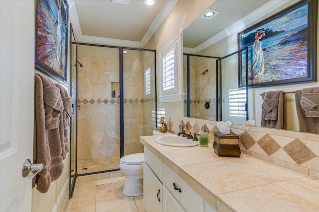 bathroom featuring vanity, a shower stall, toilet, and crown molding