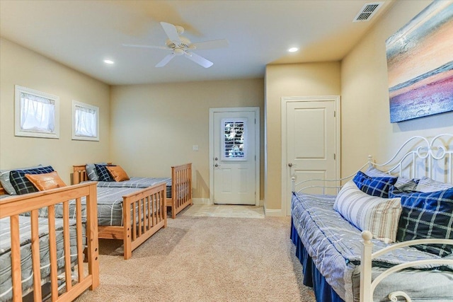 bedroom with light colored carpet, visible vents, baseboards, and recessed lighting