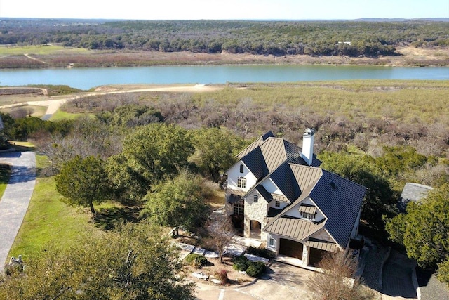 bird's eye view with a water view and a view of trees