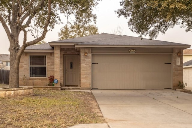 view of front of property with a shingled roof, brick siding, driveway, and an attached garage