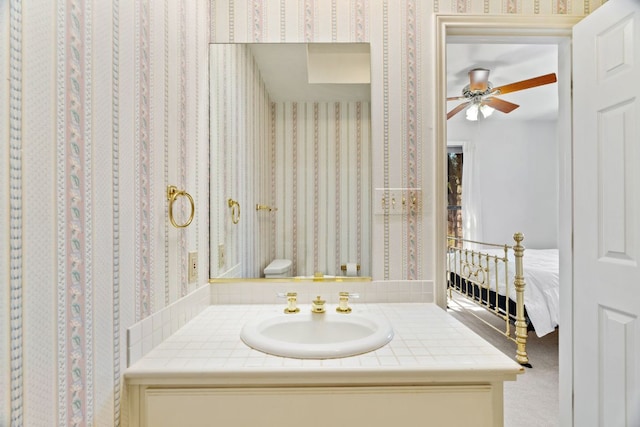 1306 Far W Rd, Horseshoe Bay, TX 78657 - bathroom with vanity, a ceiling fan, and wallpapered walls