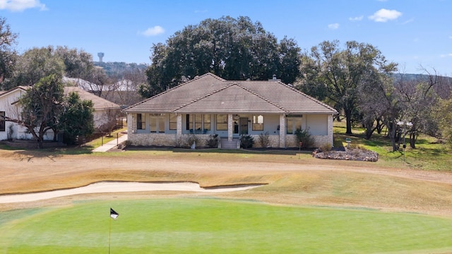 1306 Far W Rd, Horseshoe Bay, TX 78657 - view of front of home with a tile roof, view of golf course, a porch, a front yard, and stone siding
