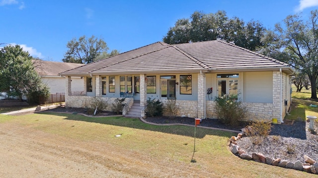 1306 Far W Rd, Horseshoe Bay, TX 78657 - view of front of home featuring a front yard, a tiled roof, and covered porch