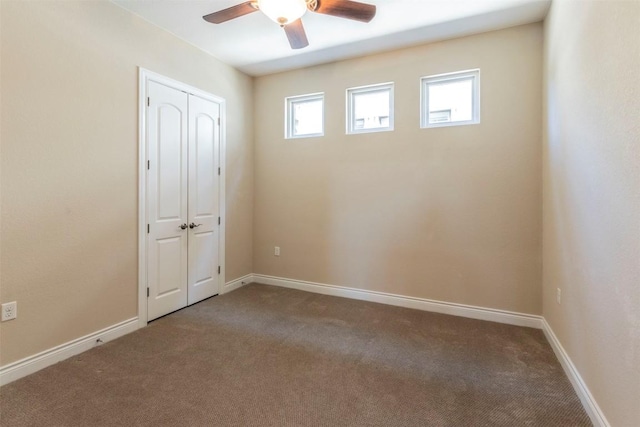 empty room featuring carpet flooring, ceiling fan, and baseboards