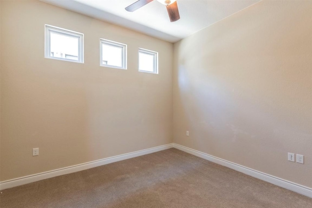 empty room featuring carpet floors, baseboards, and a ceiling fan