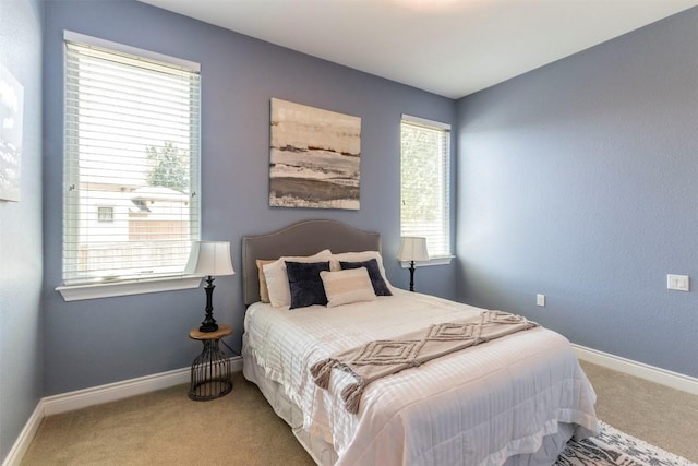 carpeted bedroom with baseboards