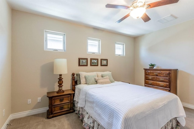 bedroom featuring multiple windows, visible vents, and light colored carpet