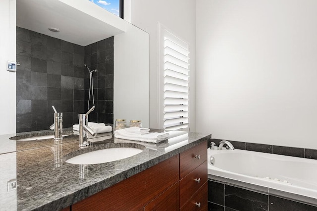 full bathroom with a tile shower, a bath, and vanity