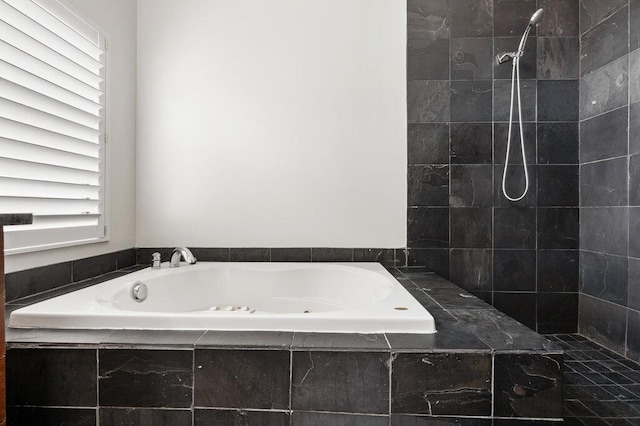 bathroom featuring a tile shower and a bath