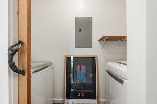 washroom with laundry area, washer and clothes dryer, and electric panel