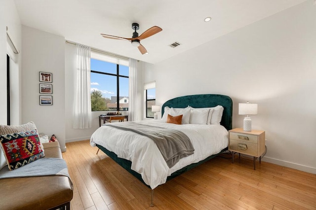 bedroom featuring recessed lighting, visible vents, light wood-style flooring, a ceiling fan, and baseboards