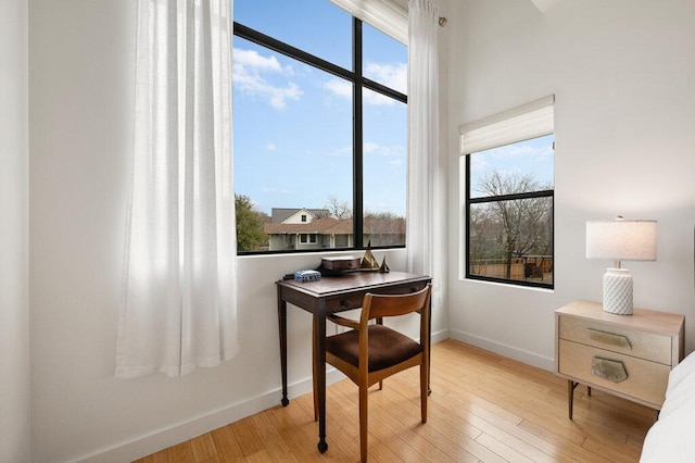 dining room featuring hardwood / wood-style floors and baseboards