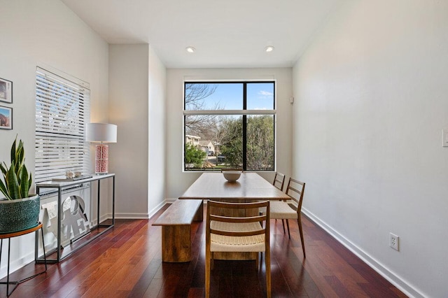 dining room with dark wood-type flooring, recessed lighting, and baseboards