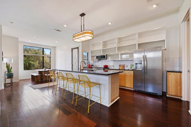 kitchen featuring decorative backsplash, dark countertops, appliances with stainless steel finishes, dark wood-type flooring, and open shelves