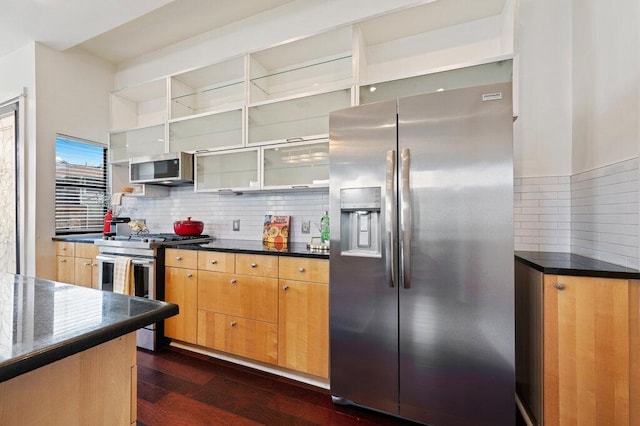 kitchen with dark wood-style floors, open shelves, stainless steel appliances, dark countertops, and backsplash