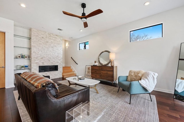 living area with a fireplace, recessed lighting, visible vents, a ceiling fan, and wood finished floors