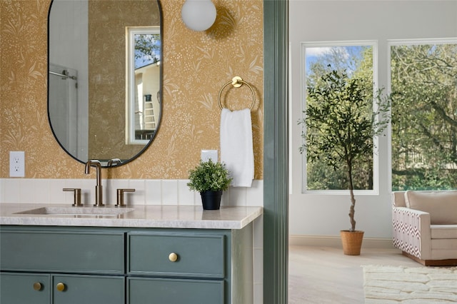 bathroom with baseboards, a wealth of natural light, and wallpapered walls