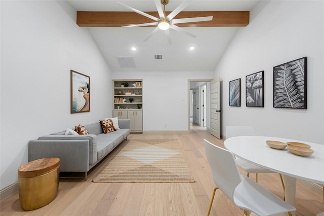 living room featuring visible vents, baseboards, a ceiling fan, light wood-style floors, and beam ceiling