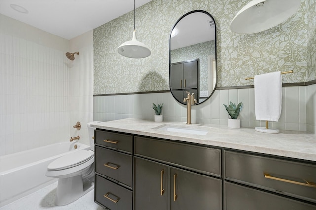 full bath featuring wainscoting, shower / bathing tub combination, vanity, and wallpapered walls