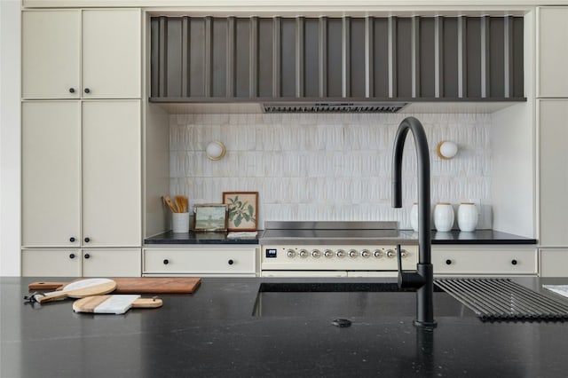 kitchen featuring dark stone counters and a sink