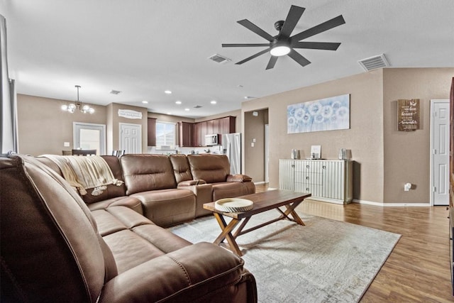 living area featuring baseboards, recessed lighting, visible vents, and light wood-style floors