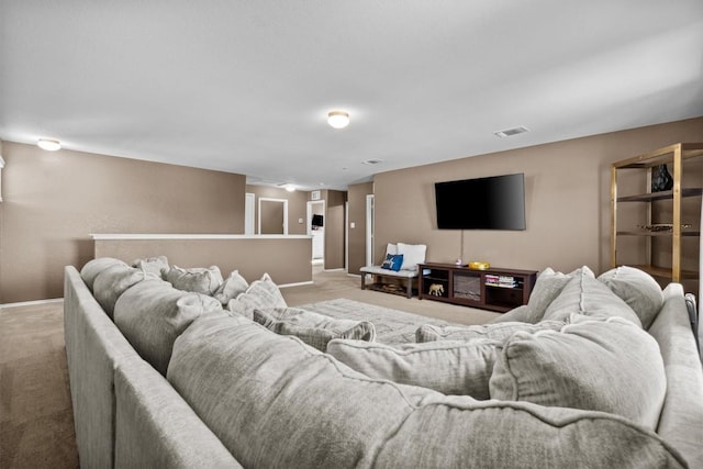 carpeted living area featuring visible vents and baseboards