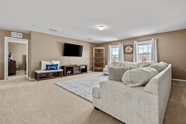 carpeted living area with visible vents and baseboards