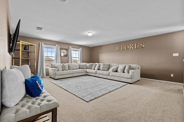 living room featuring baseboards, visible vents, a textured ceiling, and carpet flooring